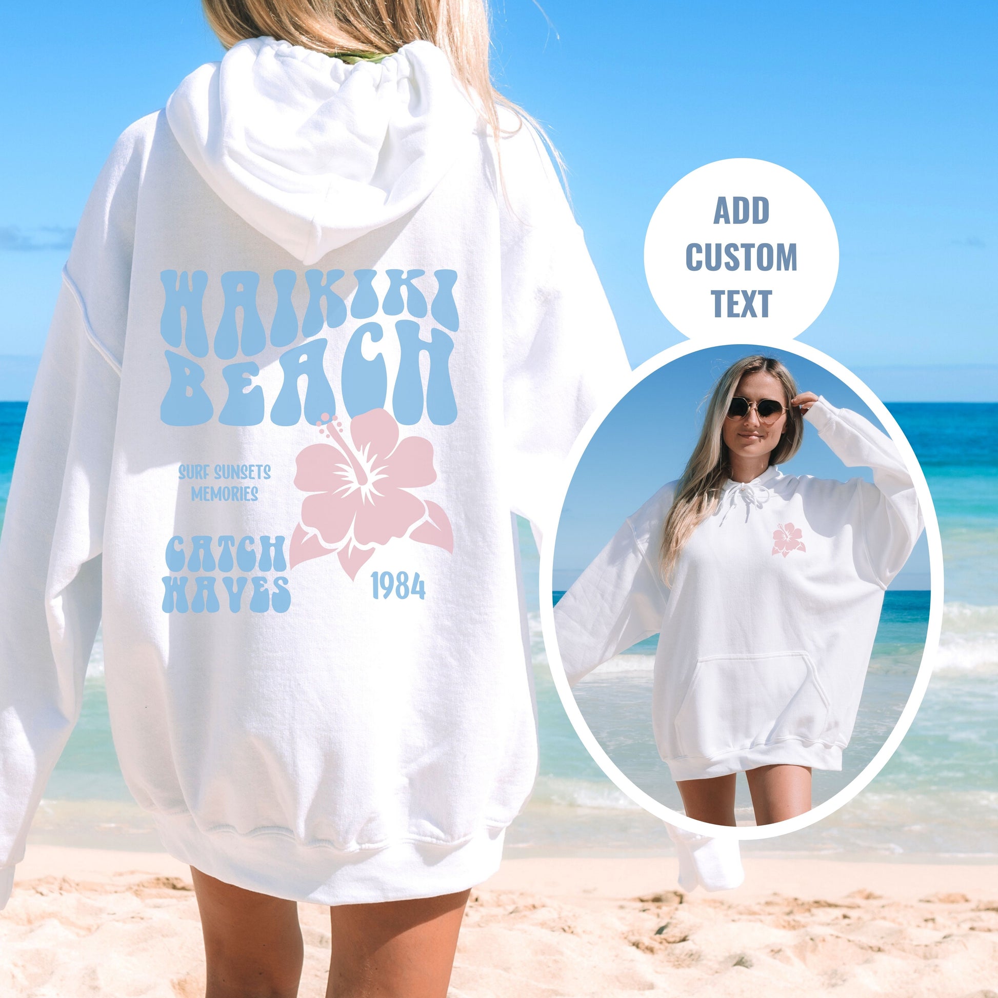 a woman standing on a beach wearing a white hoodie